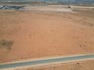Drone / aerial view of a desert landscape and a mountain backdrop
