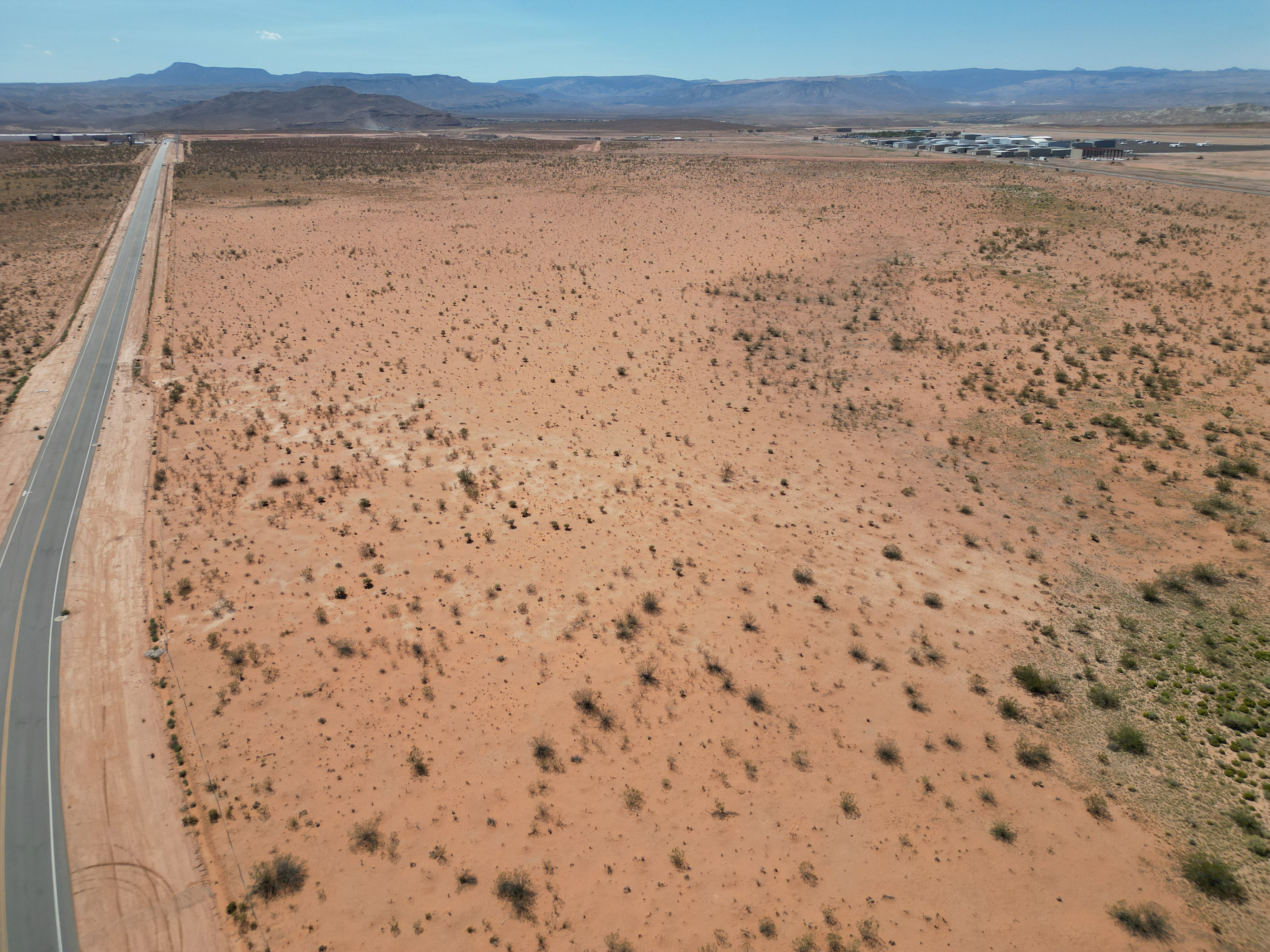 Aerial view of a mountain backdrop and a desert landscape