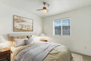 Bedroom featuring carpet floors and a ceiling fan. Staged
