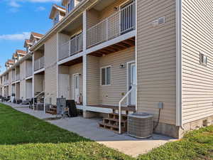 Surrounding community featuring a patio area, entry steps, a lawn, a balcony, and a residential view
