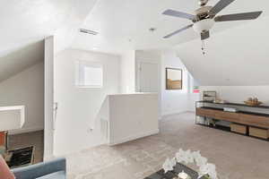 Additional living space featuring vaulted ceiling, carpet floors, a textured ceiling, and ceiling fan. Staged