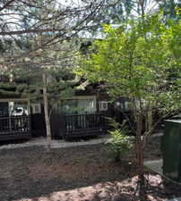 Rear view of house with a wooden deck