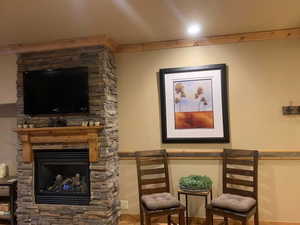 Sitting room with wood finished floors and a fireplace