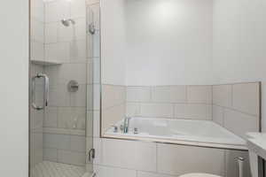 Full bath featuring a stall shower and a bath