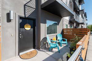 Entrance to property featuring stone siding and stucco siding
