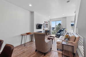 Living area featuring hardwood / wood-style flooring and recessed lighting