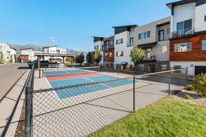 View of pool featuring a tennis court, a mountain view, a residential view, and a patio area