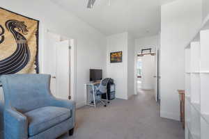 Office space featuring light carpet and ceiling fan
