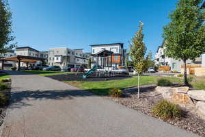 Community play area with a residential view and a lawn