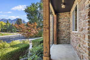 Covered porch featuring a mountain view