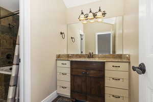 Bathroom featuring vanity and tiled shower / bath combo