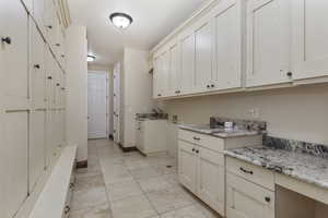 Washroom with light tile patterned floors and baseboards