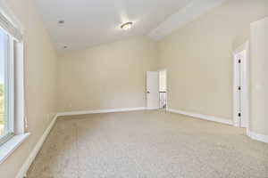 Spare room with light carpet and high vaulted ceiling