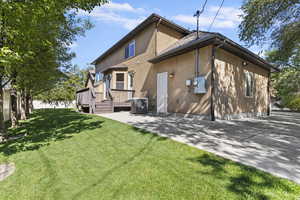 Rear view of property featuring a deck and stucco siding