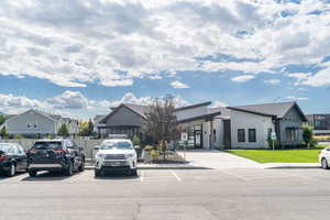View of front facade featuring uncovered parking