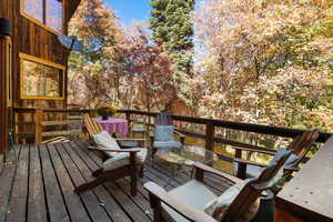 Wooden terrace featuring outdoor dining area