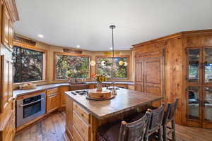 leathered granite countertops with copper sinks.  Articulated faucet on the island.
