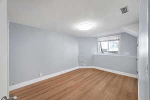 Unfurnished room featuring baseboards and light wood-style floors