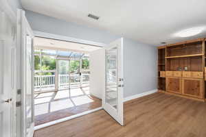 Doorway featuring wood finished floors and french doors