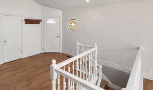 Foyer entrance featuring dark wood-style flooring, recessed lighting, and lofted ceiling