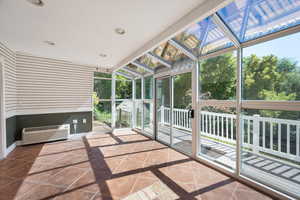 Unfurnished sunroom with a wall unit AC