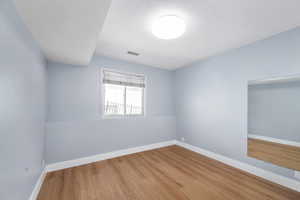 Spare room with wood finished floors and baseboards