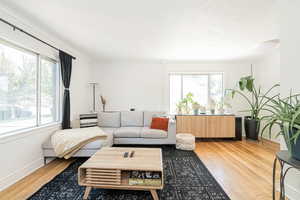 Living area featuring light wood-style flooring and ornamental molding