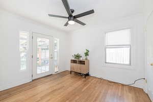 Doorway to outside with crown molding, hardwood / wood-style floors, and a ceiling fan