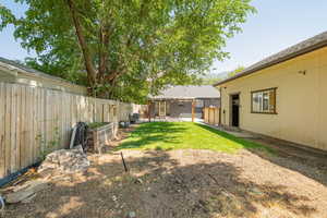 Fenced backyard with a patio area and a mountain view