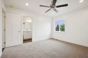 Unfurnished bedroom featuring carpet flooring, recessed lighting, a ceiling fan, and connected bathroom