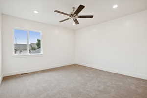 Spare room with light colored carpet, recessed lighting, and ceiling fan