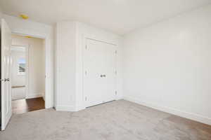 Unfurnished bedroom with carpet floors and a closet