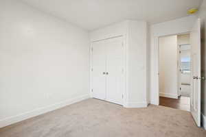 Unfurnished bedroom with carpet floors and a closet