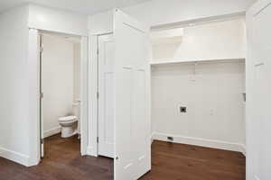 Laundry room with dark wood-style flooring, electric dryer hookup, and hookup for a washing machine