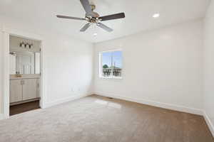 Unfurnished bedroom with carpet flooring, ceiling fan, recessed lighting, and connected bathroom