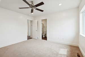 Unfurnished bedroom featuring carpet, ceiling fan, ensuite bathroom, and recessed lighting