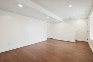 Basement with wood finished floors and recessed lighting