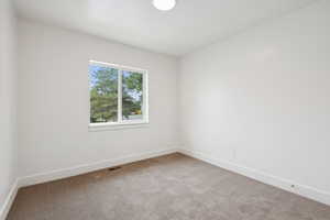 Unfurnished room with carpet flooring and baseboards