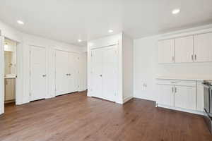 Unfurnished dining area with recessed lighting and dark wood-style flooring