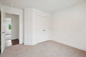 Unfurnished bedroom with carpet floors and a closet