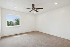 Unfurnished room featuring light carpet, recessed lighting, and a ceiling fan