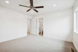 Unfurnished bedroom featuring carpet, ceiling fan, recessed lighting, and ensuite bath