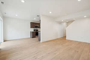 Unfurnished living room with recessed lighting and light wood finished floors