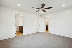 Unfurnished bedroom with ensuite bathroom, recessed lighting, light carpet, and ceiling fan