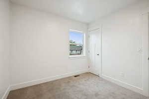 Unfurnished room featuring carpet floors and baseboards