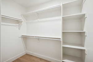 Walk in closet featuring light wood-style floors