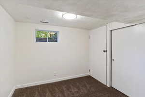 Unfurnished room with carpet and baseboards