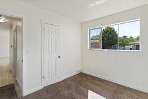 Unfurnished bedroom featuring carpet floors and a closet