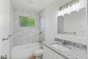 Full bathroom with shower / bath combination and vanity