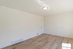 Spare room with light wood-style flooring